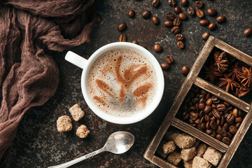Coffee board with coffee beans on dark textured background.