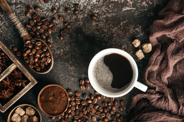 Coffee board with coffee beans on dark textured background.