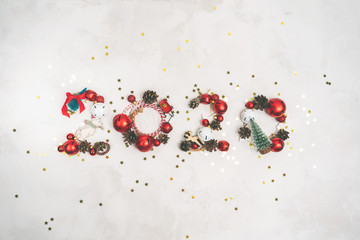 Number 2020 made of vintage tree toys for New Year celebration and festive background, confetti stars and decorations top view. Christmas layout.