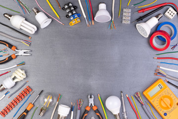Electrician equipment on metalic background, top view with copy space
