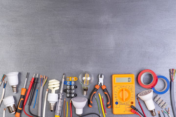 Electrician equipment on metalic background, top view	