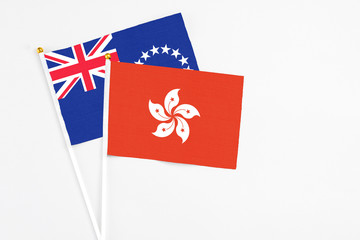 Hong Kong and Cook Islands stick flags on white background. High quality fabric, miniature national flag. Peaceful global concept.White floor for copy space.