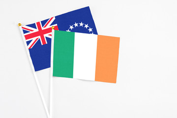 Ireland and Cook Islands stick flags on white background. High quality fabric, miniature national flag. Peaceful global concept.White floor for copy space.