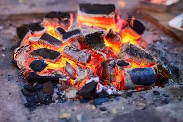 Close up of red hot coals glowed in the stove.