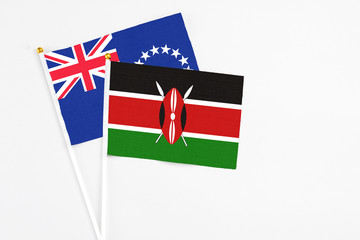 Kenya and Cook Islands stick flags on white background. High quality fabric, miniature national flag. Peaceful global concept.White floor for copy space.