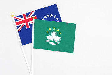 Macao and Cook Islands stick flags on white background. High quality fabric, miniature national flag. Peaceful global concept.White floor for copy space.
