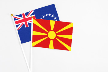 Macedonia and Cook Islands stick flags on white background. High quality fabric, miniature national flag. Peaceful global concept.White floor for copy space.