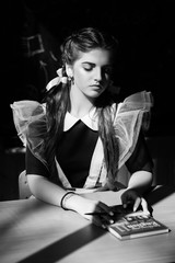 Always full of inspiration. Girl back to school. Adorable girl with tied hair in ponytails in...