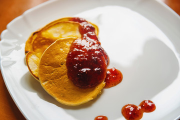 Hot pancakes with jam on the table