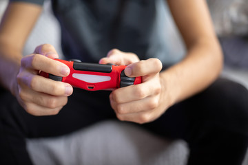young man playing video game with gamepad front view