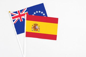 Spain and Cook Islands stick flags on white background. High quality fabric, miniature national flag. Peaceful global concept.White floor for copy space.