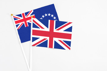 United Kingdom and Cook Islands stick flags on white background. High quality fabric, miniature national flag. Peaceful global concept.White floor for copy space.