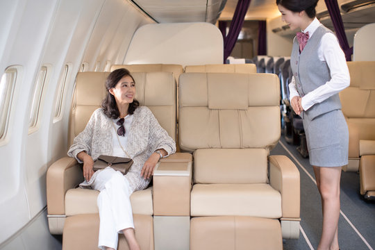 Chinese flight attendant and passengers on plane