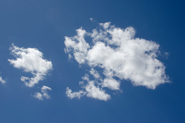 Naklejka na ściany i meble White clouds on a blue sky. Background.