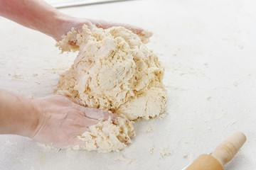 Hands chef knead dough for pizza. Knead dough with your hands. Woman's hands knead dough. Cooking pizza.