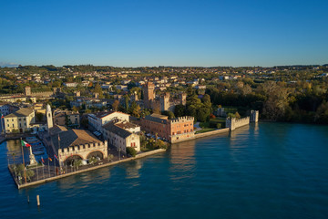 Aerial view of Lake Garda and the city center of Lazise, Italy. Autumn season, blue sky