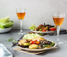 Baked chicken legs with vegetables and mushrooms with salad and thyme.
