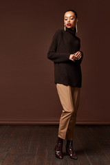Beautiful sexy woman long brunette hair glamour model wear pants and sweater work office style...