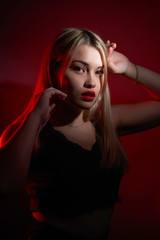portrait of a beautiful girl with red lips on a red background