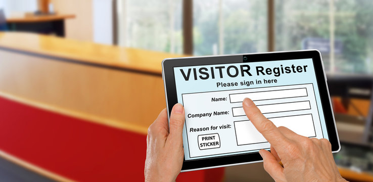 Visitor completing a sign in register form on computer tablet