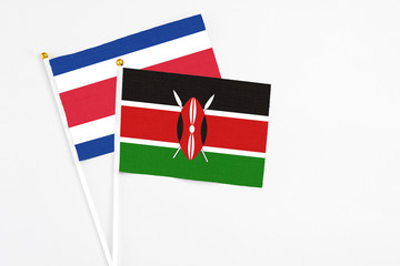 Kenya and Costa Rica stick flags on white background. High quality fabric, miniature national flag. Peaceful global concept.White floor for copy space.