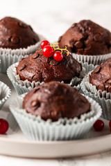 Chocolate muffins with zucchini. Muffins served with redcurrant.