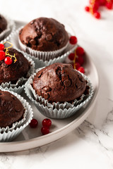 Chocolate muffins with zucchini. Muffins served with redcurrant.