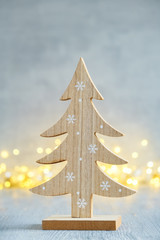 Wooden christmas tree and christmas lights on background.  Greeting card.