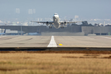 Airplane taking off from an airport, with great sun