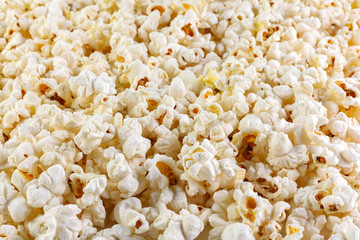 Heap of delicious popcorn, isolated on white background . Scattered popcorn texture background. Selective focus.