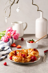 Croissants with fresh strawberries and raspberries. Romantic breakfast