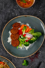 Falafels with rice and vegetables. Healthy vegetarian lifestyle.