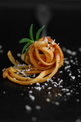 Fork with spaghetti. Spaghetti napoli with black pepper and parmesan cheese, served with rosemary