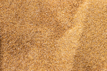 uncooked raw wheat groats supermarket weight counter background 