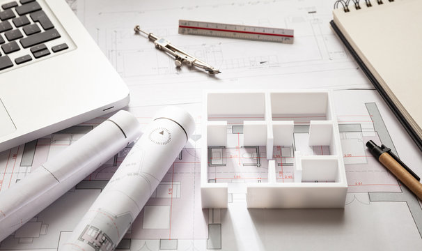 Construction concept. Residential building drawings and house model,