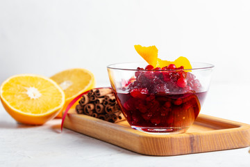 Thanksgiving cranberry sauce in glass bowl with fresh orange and lemon