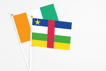 Central African Republic and Cote D'Ivoire stick flags on white background. High quality fabric,...