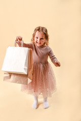 Small fashion girl . happy shopping girl runs with full bags and laughs. black Friday discount. cyber Monday. Present and gifts buy. summer sales. copy space.