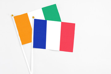 France and Cote D'Ivoire stick flags on white background. High quality fabric, miniature national...