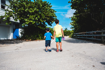 mother and daughter walking on beach