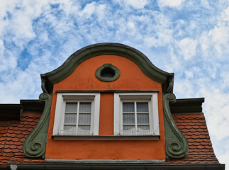Decorative Curved Roof with Upper Windows and Scroll Support and Red Roof