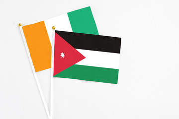 Jordan and Cote D'Ivoire stick flags on white background. High quality fabric, miniature national...