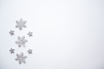 Obraz premium Christmas frame made Silver stars on white background. Winter concept. Flat lay, top view, copy space.Christmas composition.