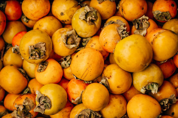  ripe tasty orange persimmon on the food market