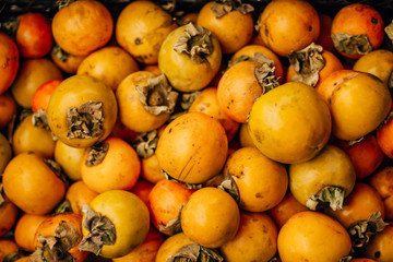  ripe tasty orange persimmon on the food market