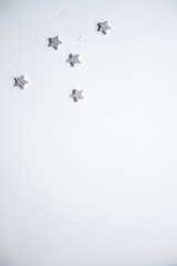 Christmas frame made Silver stars on white background. Winter concept. Flat lay, top view, copy space.Christmas composition.