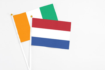 Netherlands and Cote D'Ivoire stick flags on white background. High quality fabric, miniature...