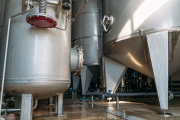 Steel reservoirs, tanks and pipes in modern water production factory. Industrial background.