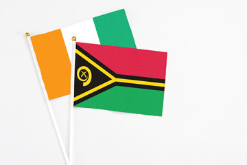 Vanuatu and Cote D'Ivoire stick flags on white background. High quality fabric, miniature national...