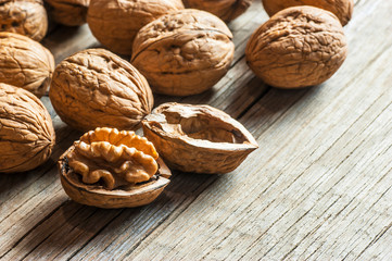 Ripe and raw whole big walnut kernel with thin shell on wooden rustic backdrop. healthy nut food for brain. Fresh walnuts background concept